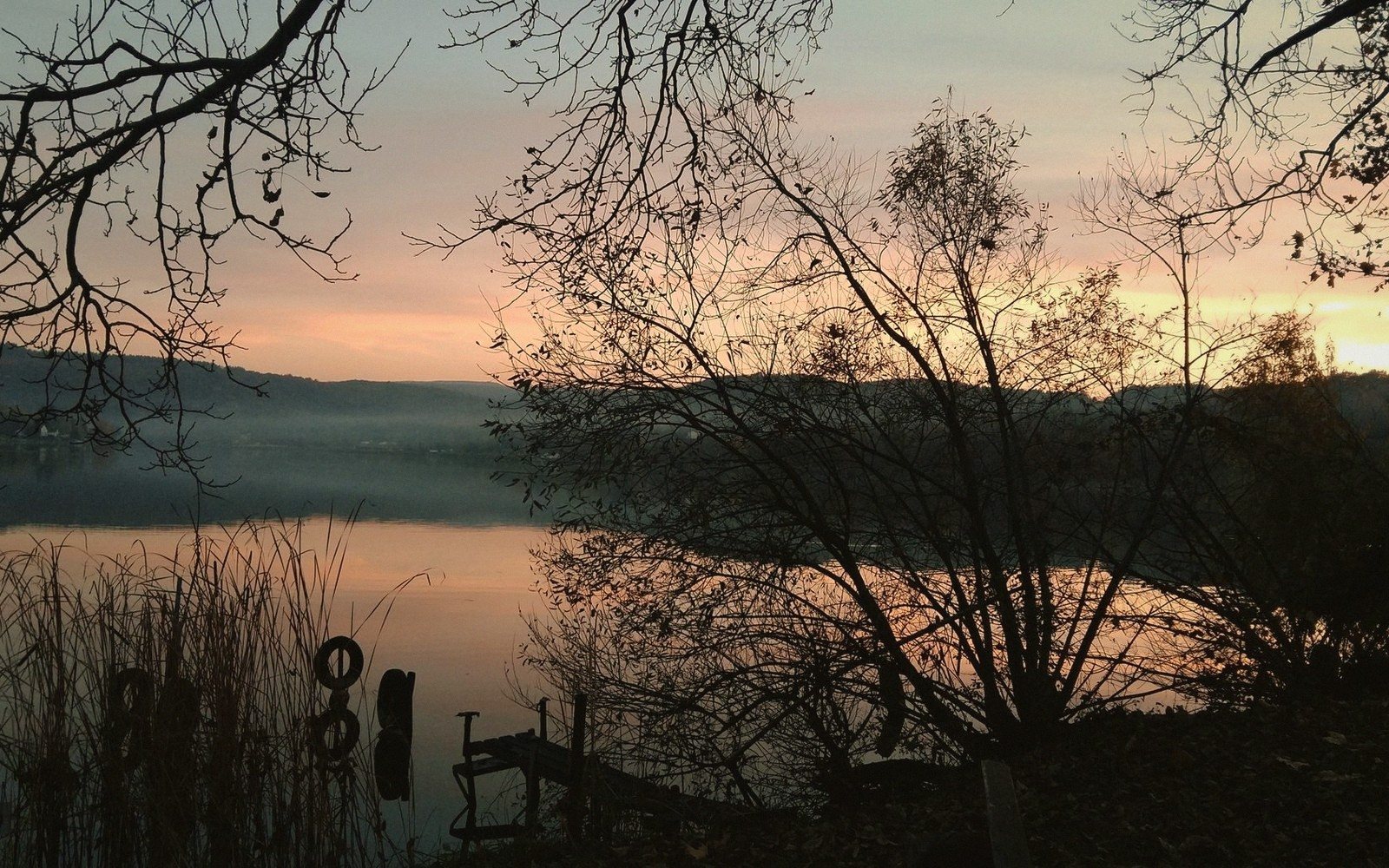 a wide lake at dusk under an open sky